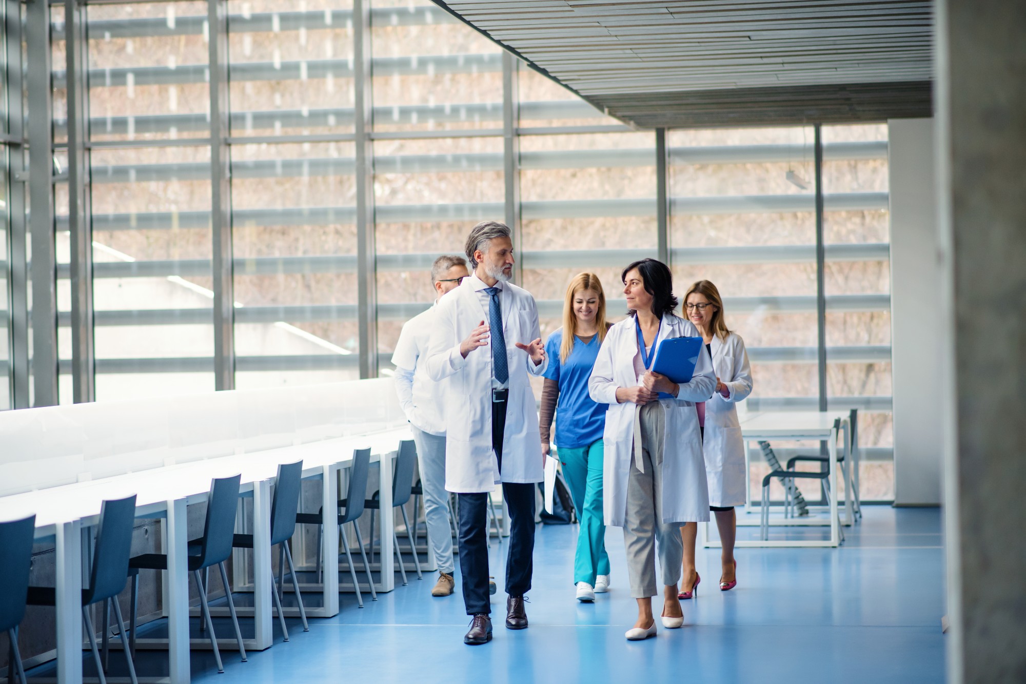 Doctors and nurses walking together in a hospital hallway