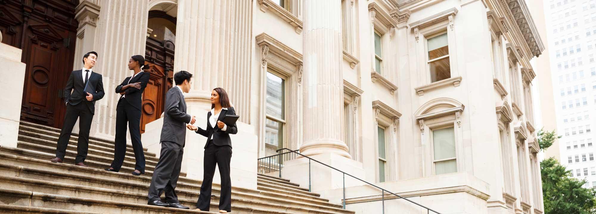 Lawyers standing in front of a city hall building