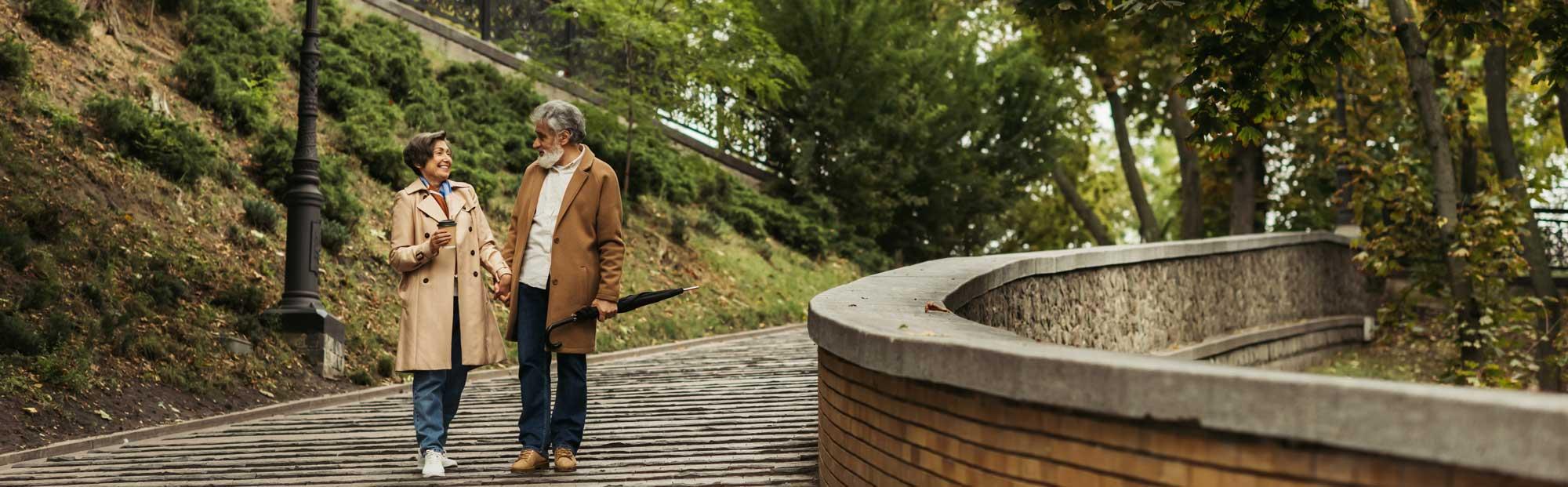 An elderly couple walking together, enjoying a date